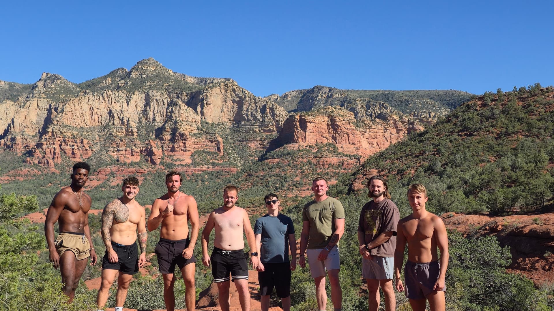 A group standing together in front of Northern Arizona red rock mountains